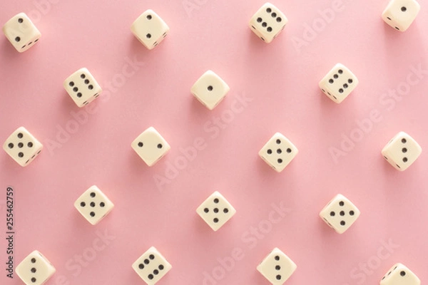 Fototapeta White gaming dices on pink background. victory chance, lucky. Flat lay, place for text. Top view. Close-up. Concept gamble. spectacular pastel