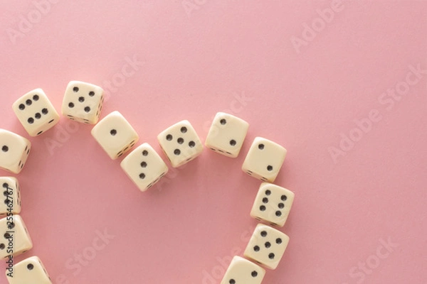 Obraz White gaming dices on pink background. victory chance, lucky. Flat lay, place for text. Top view. Close-up. Concept gamble. spectacular pastel