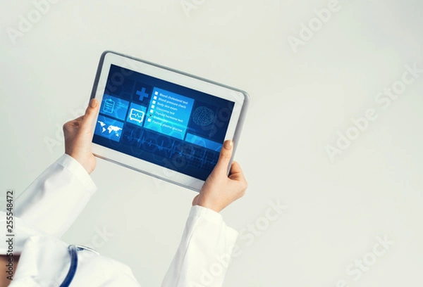 Obraz Close of female doctor hands working with tablet pc computer