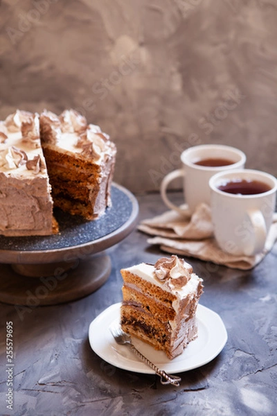 Fototapeta Homemade Kiev cake, dacquoise cake with butter cream and hazelnuts. Gradient  layers in brown shades