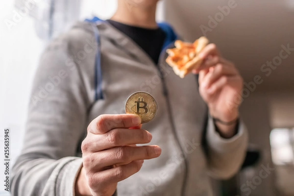 Fototapeta Bitcoin pizza day anniversary. The first reported exchange of cryptocurrency for a consumer product on May 22, 2010.