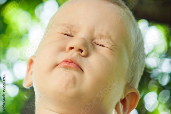 Obraz The little boy the kid squeezed his eyes and does not want to see anything. The child refuses to comply with the request.