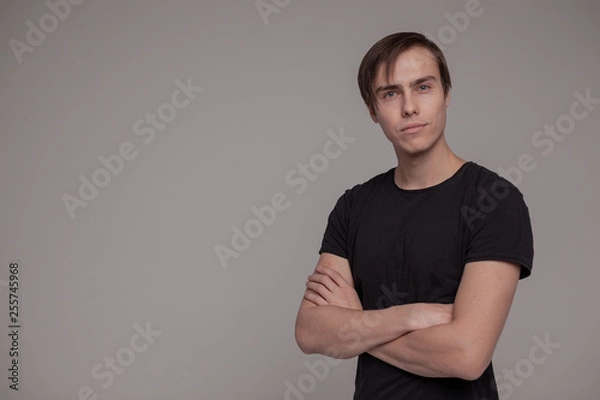 Fototapeta White young man in a black T-shirt.