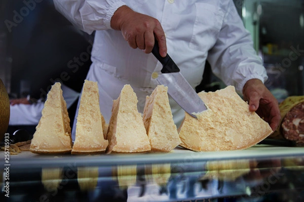 Obraz person slicing cheese