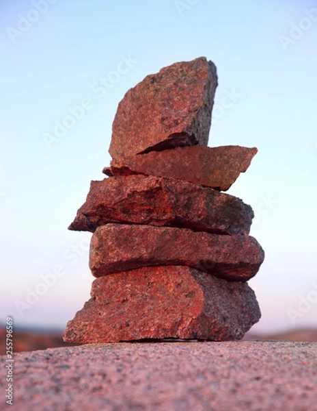 Fototapeta mysterious stone pyramid in the pink rays of the setting sun