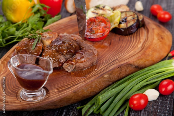 Fototapeta  juicy and appetizing steak tamogavok of horse meat on the table, for design in cooking