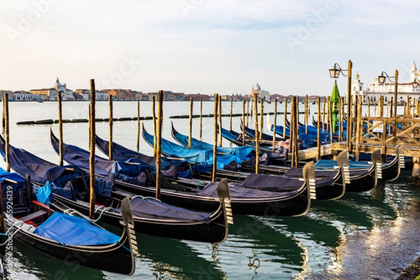 Fototapeta Empty gondolas floating on a lagoon of Venice, Italy