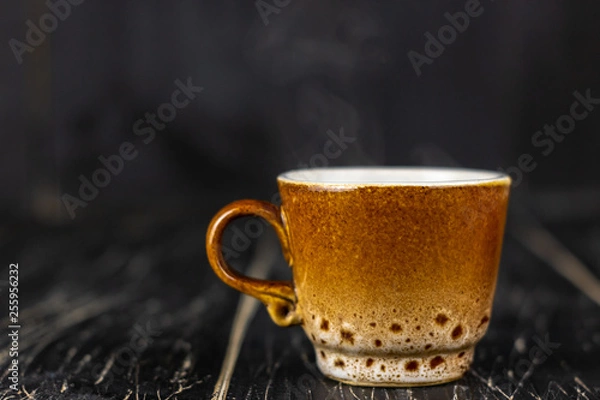 Obraz Bright autumn background - cup of coffee on rustic wooden table with place for text. Yellow coffee mug. Bright autumn still life against autumn depression. Coffee break concept. Top view. Copy space