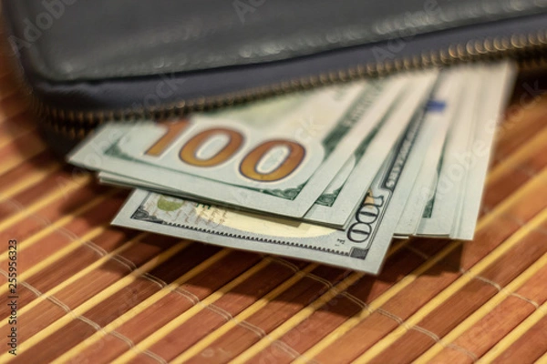 Obraz Fan hundred dollar bills in a black wallet