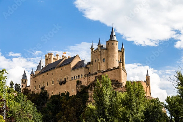 Fototapeta The famous view of the Alcazar of Segovia in a sunny summer day from the view point of la Pradera de San Marcos, Segovia, Castilla y Leon, Spain