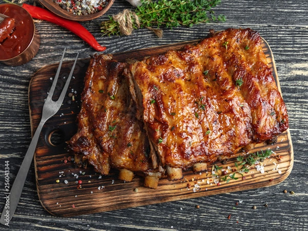Fototapeta grilled pork ribs with sauce on a cutting board , spice, marinade