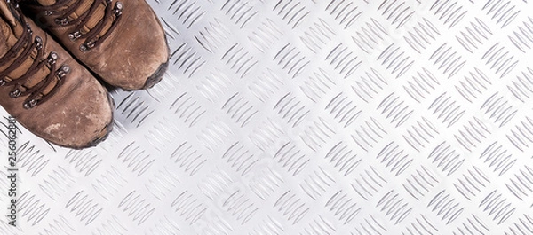Fototapeta Dirty safety boots on metalic background