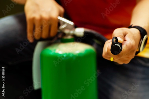Fototapeta Man using  fire extinguisher.