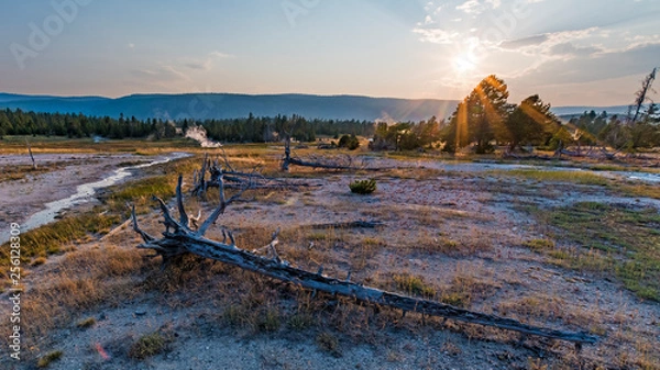 Fototapeta Sunbeams over harsh terrain