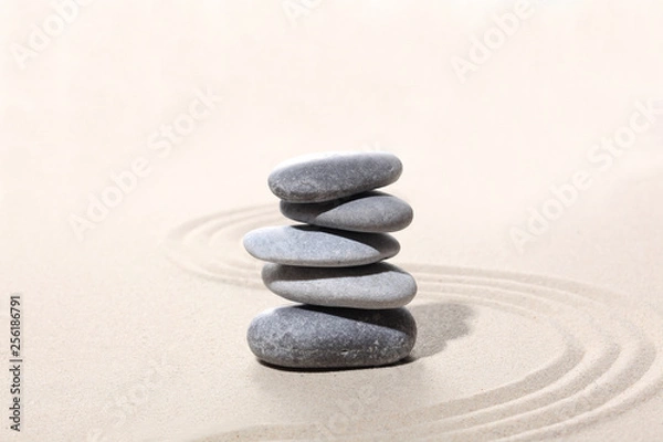 Fototapeta zen stone concept, grey stones piled on the sand with copy space for your text
