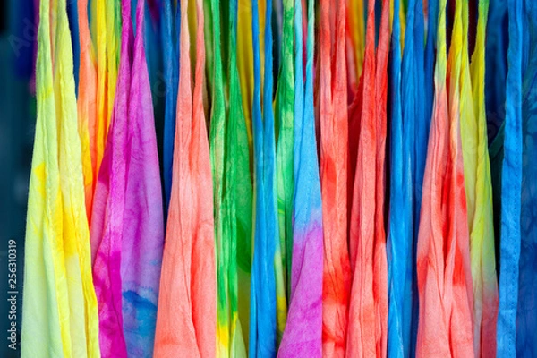 Fototapeta Summer clothes on hangers for sale in local street market in Thailand, close up