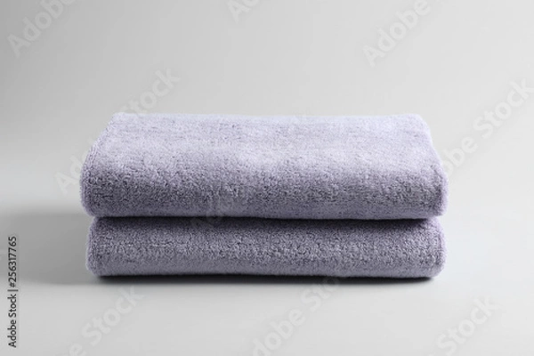 Fototapeta Stack of fresh fluffy towels on grey background