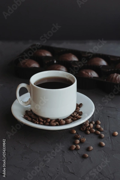 Fototapeta Chocolate cakes and cup of coffee on dark background