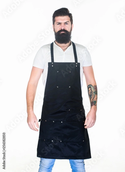 Fototapeta Staying clean and comfortable with chef apron. Bearded man cook in kitchen apron. Cook with long beard wearing bib apron. Master cook in cooking apron with pockets. Grill cook isolated on white