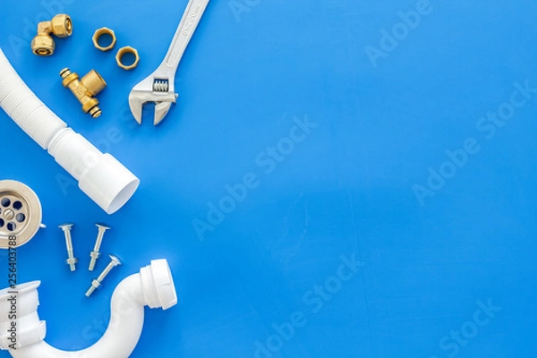Obraz Plumber work with instruments, tools and gear on blue background top view mock up