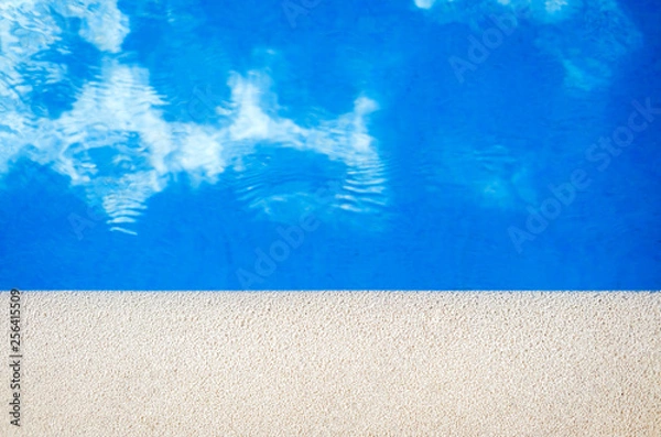 Obraz Closeup view of the swimming pool edge with blue water copy space during a sunny summer day