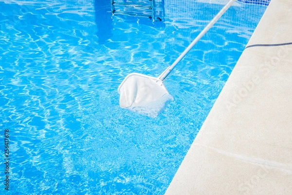 Obraz swimming pool cleaning tool with a net on the blue water