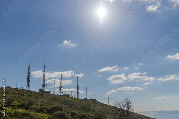Obraz cellular antennas against a blue sky