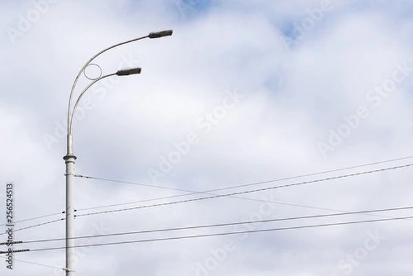 Obraz street lights with electrical wires in the city against a blue sky