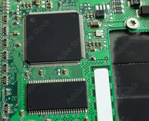 Fototapeta Computer board with a processor and transistors.