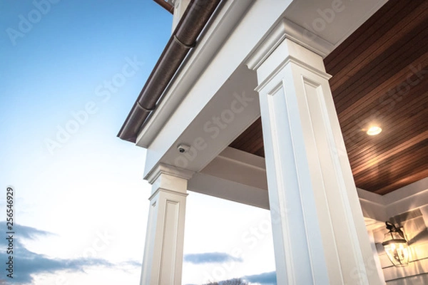 Fototapeta Strong columns and trim of modern home exterior.