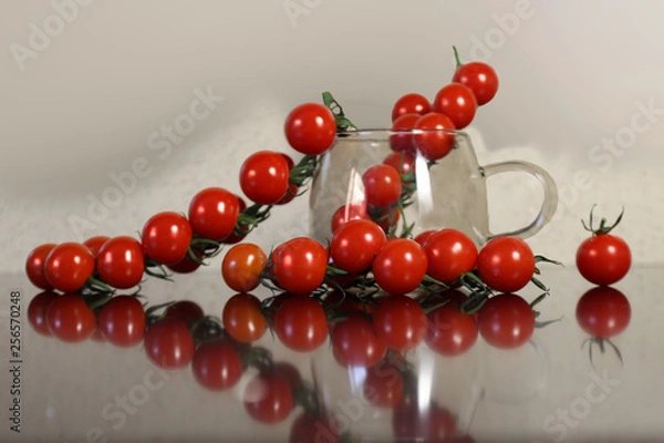 Fototapeta A branch of ripe tomatoes lying on the table