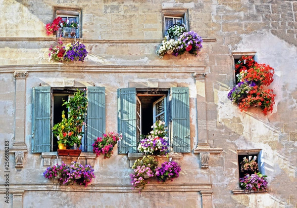 Fototapeta Typical facade of the old Provencal retro house with windows and wooden shutters decorated with colorful fresh flowers in Provence, Cote d'Azur, France