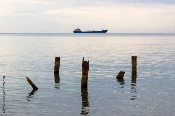 Fototapeta Tranquil seascape with ship at background