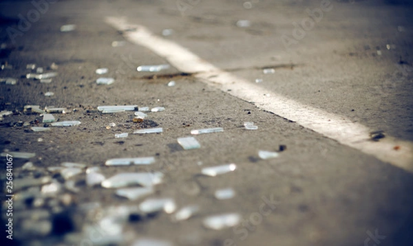Fototapeta The shards of automotive glass in the accident, lying on the pavement about dividing the solid lines on the roadway