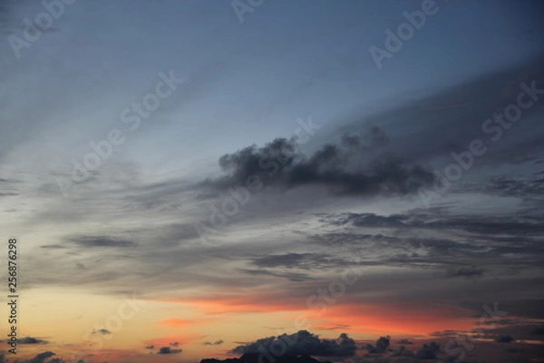 Obraz uninhabited island in the ocean against the red sunset