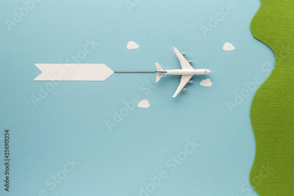 Fototapeta airplane flying over blue sky with clouds  top view with copy space for your text. flat lay. 
