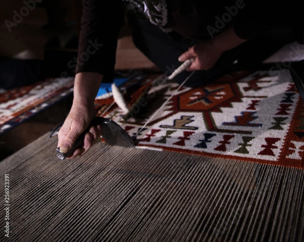 Obraz Weaving carpet with traditional techniques on a loom. Wool yarns used as a warp and weft is crucial for this art.Turkey
