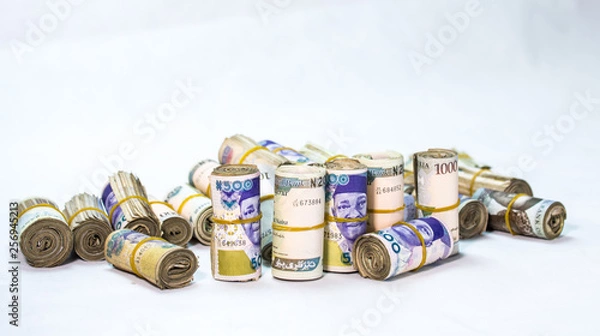 Fototapeta Rolls and Bundles of Naira Cash local currencies in a pyramid heap