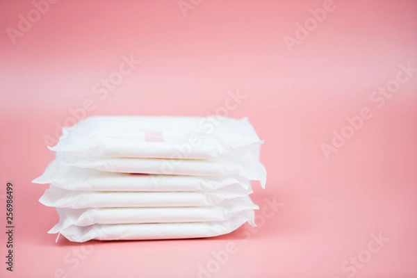 Obraz Stacked sanitary napkin pad on pink background.