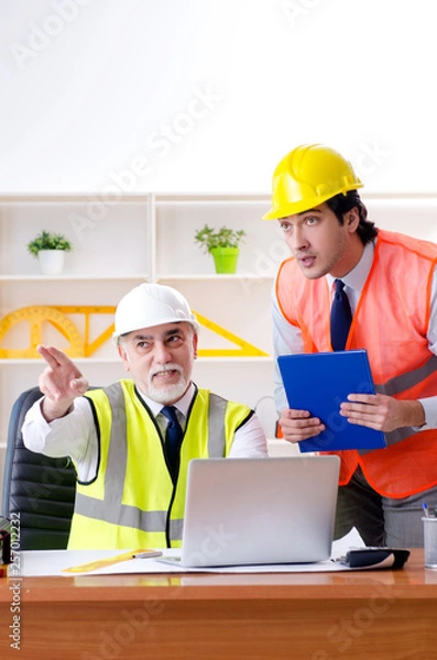 Fototapeta Two engineers colleagues working under project