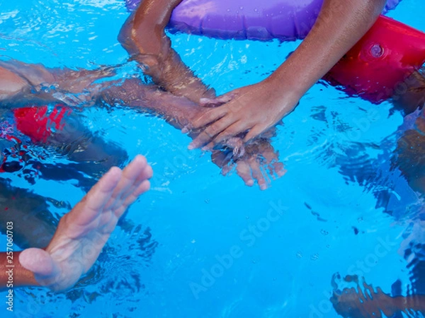 Fototapeta playing with children's hands in the pool