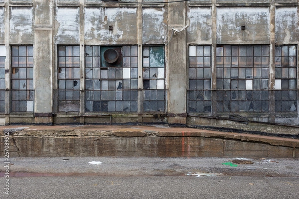 Fototapeta Multicolored windows of an abandoned factory in an urban industrial area