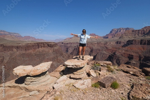 Obraz Young female backpacker enjoying a sweeping view of the canyon from the Tonto Trail in Grand Canyon National Park, Arizona.