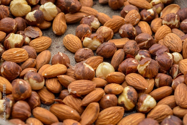 Fototapeta Health concept. Hazelnuts and almonds on a pan close-up. Vegetarian nutrition. Vegan dinner. Natural background.