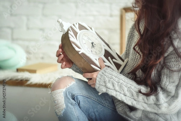 Fototapeta Young girl starting retro clock