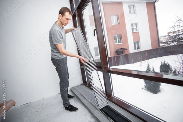 Fototapeta Warm floor. Heating system. Instalaltion of heating convector built into the concrete floor. Repair and renovation in house. Comfort climate at home..