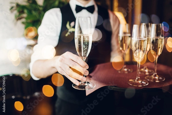 Obraz Champagne glasses on sparkling background.