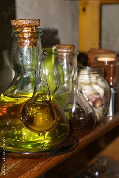 Obraz jars of oil and vinegar in bookshelf