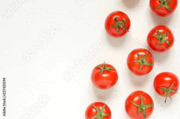 Fototapeta Raw tomatoes on a light concrete background.Top view with copy space. - Image