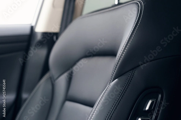 Obraz Leather car interior. Modern car illuminated dashboard. Luxurious car instrument cluster. Close up shot of automobile instrument panel. Modern car interior dashboard and steering wheel